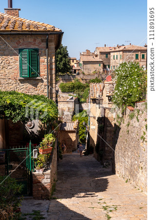 Narrow alley at the city wall of Volterra, Tuscany 111891695