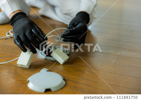 Workers installing wiring on the floor 111891750