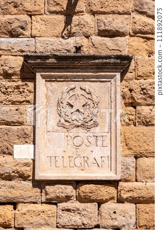 Old post office sign with a Socialist star in Volterra 111892075