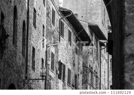Facade of typical medieval residential houses in downtown San Gimignano 111892129