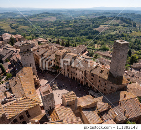 Wide panoramic view over downtown San Gimignano with Torre del Diavolo and Torre dei Becci, seen from Torre Grosso 111892148