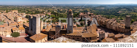 Wide panoramic view over downtown San Gimignano, Torri dei Salvucci and Torre Rognosa in the center, seen from Torre Grosso 111892151