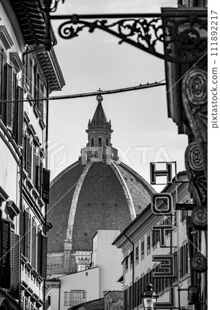 Cupola of the cathedral Santa Maria del Fiore in Florence, seen from a street far away Cupola of the cathedral Santa Maria del Fiore in Florence, seen from a street far away 111892217