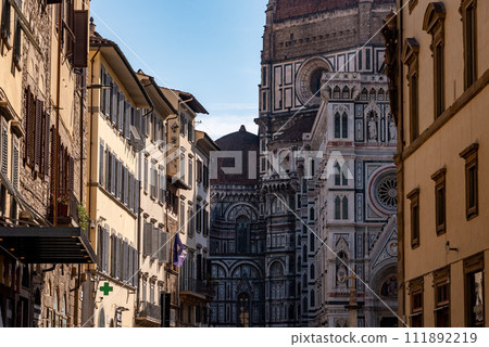 The cathedral Santa Maria del Fiore in Florence, seen from a street further away The cathedral Santa Maria del Fiore in Florence, seen from a street further away 111892219