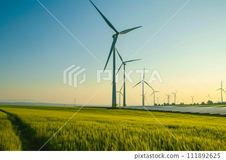 Sustainable Energy Oasis: Wind Turbines and Solar Panels Coexist Sustainable Energy Oasis: Wind Turbines and Solar Panels Coexist 111892625