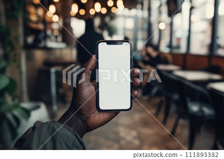 Digital Dialogue: Black Man's Hand with Phone in Cafe 111893382