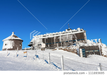 Wooden building of new post office and Roman catholic chapel in snezka, mountain on the border between Czech Republic and Poland, winter morning 111893695