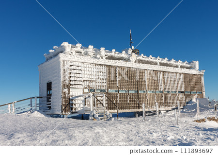 Wooden building of new post office with souvenirs and postcards in snezka, mountain on the border between Czech Republic and Poland, winter morning. 111893697
