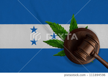 Justice wooden gavel with cannabis leaf on the Flag of Honduras. Illegal growth of cannabis plant and drugs spreading 111894596