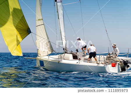 Sailing boat in light wind during regatta competition 111895973