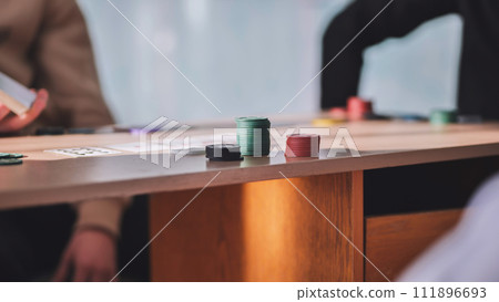 Young guys playing poker at a table. 111896693