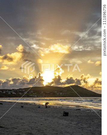 20 man are competing in a fishing competition on the beach. 20 man are competing in a fishing competition on the beach. 111896756