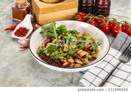 White canned beans with arugula and dry tomatoes 111896836