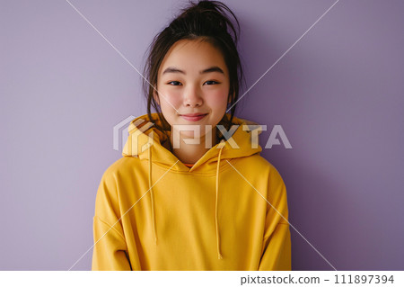 Asian happy teenage girl wearing hoodie on purple background 111897394