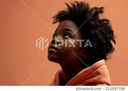 African American serious teenage girl wearing hoodie on peach background 111897396