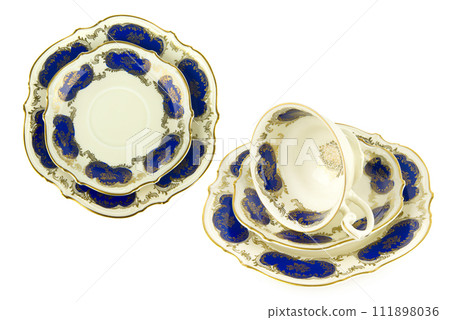 Porcelain vintage cup saucer and plate isolated on white. Vintage Bavarian teaware. Collage. Porcelain vintage cup saucer and plate isolated on white. Vintage Bavarian teaware. Collage. 111898036