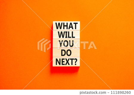 What will you do next symbol. Concept words What will you do next on wooden blocks. Beautiful orange table orange background. Business, what will you do next concept. Copy space. 111898260