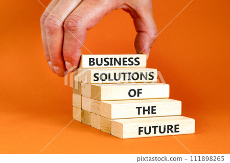Business solutions of the future symbol. Concept words Business solutions of the future on wooden blocks. Beautiful orange table orange background. Business solutions of the future concept. Copy space 111898265