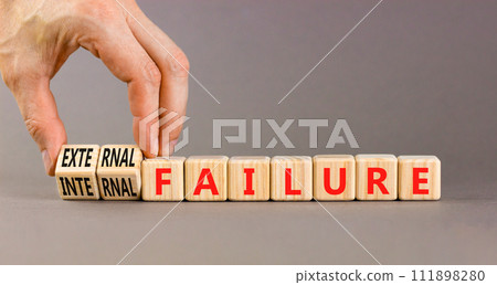 External or internal failure symbol. Concept words External failure or Internal failure on blocks. Beautiful grey background. Businessman hand. Business external internal failure concept. Copy space 111898280