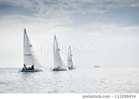 Group of yachts sailing in the wind during regatta 111898454