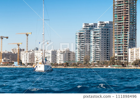 View of a moored yacht in front of Limassol cityscape. Cyprus 111898496
