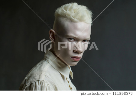 Authentic handsome man with fair skin and white hair on a grey background 111898573