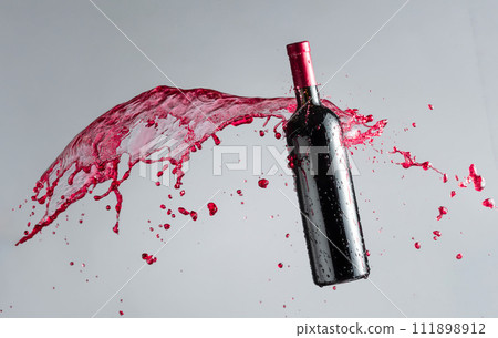 Bottle of red wine and splashes. Bottle of red wine and splashes. 111898912