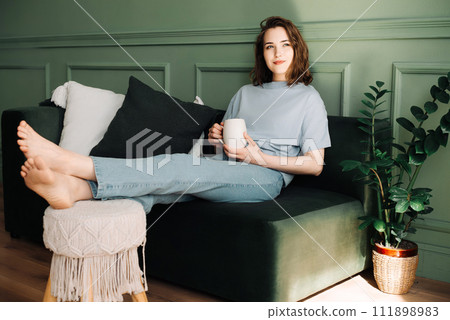 Serene Modern Lifestyle - Confident, Stylish Woman in Cozy Home Setting with Tea Coffee. Elegant 111898983