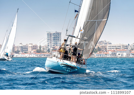Sailing crew on sailboat during regatta at Larnaca bay 111899107