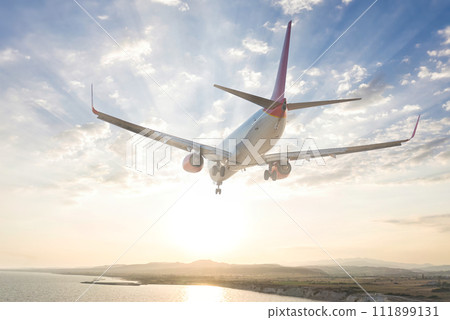 Airliner flying over Alaminos coast, Larnaca District, Cyprus 111899131