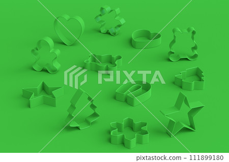 Set of metal cookie cutters for homemade Christmas biscuit on green monochrome Set of metal cookie cutters for homemade Christmas biscuit on green monochrome 111899180