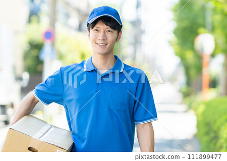 A courier male driver delivering a package 111899477