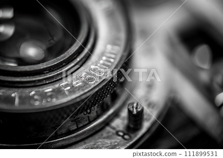 Closeup of an old retro film camera lens Closeup of an old retro film camera lens 111899531