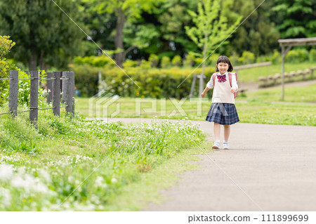 Smiling girl carrying a parcel 111899699