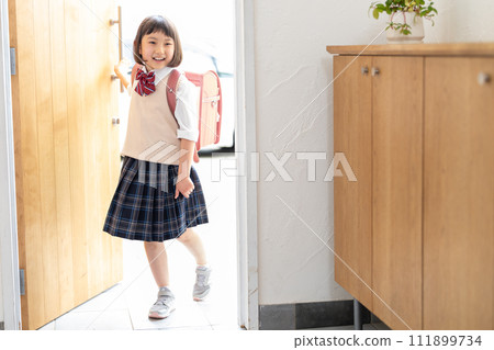 Elementary school girl standing at the entrance Elementary school girl standing at the entrance 111899734