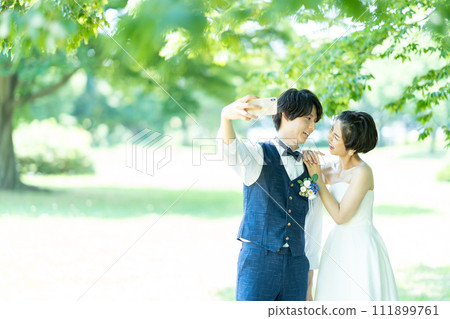 bride and groom taking photos 111899761