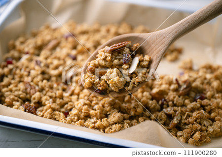homemade granola in iron pan homemade granola in iron pan 111900280
