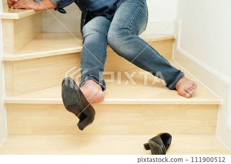 Asian business woman pain ankle, foot with leg cramp and fall down the stairs because slippery surfaces in office. 111900512