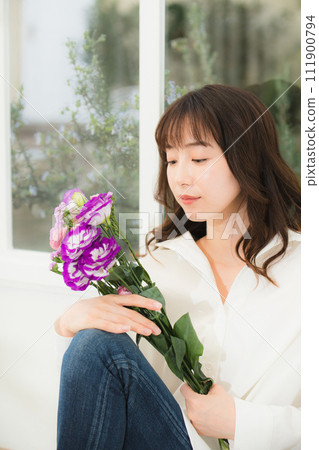 Young woman with a bouquet of flowers beauty image 111900794