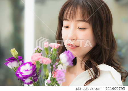 Young woman with a bouquet of flowers beauty image 111900795
