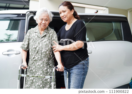 Caregiver help Asian elderly woman disability patient get in her car, medical concept. Caregiver help Asian elderly woman disability patient get in her car, medical concept. 111900822