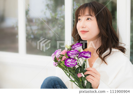 Young woman with a bouquet of flowers beauty image 111900904