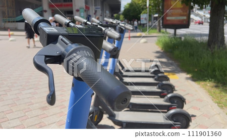 Electric scooters are on the street waiting to be rented. Electric scooters are on the street waiting to be rented. 111901360