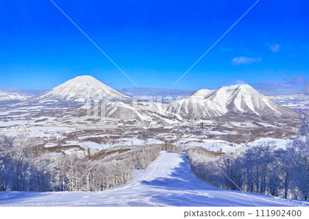 View of Mt. Yotei and Rusutsu Ski Resort from inside the slopes of Rusutsu Ski Resort in Hokkaido, Japan on a clear day in the middle of winter View of Mt. Yotei and Rusutsu Ski Resort from inside the slopes of Rusutsu Ski Resort in Hokkaido, Japan on a clear day in the middle of winter 111902400