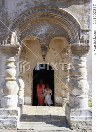 Mother and daughter enter Church of the Savior on Spilled Blood in monastery in Rostov the Great Mother and daughter enter Church of the Savior on Spilled Blood in monastery in Rostov the Great 111902837