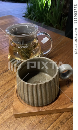 A jar of tea with empty glass A jar of tea with empty glass 111903778