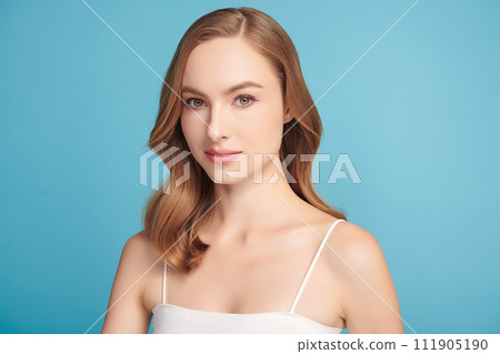 Beautiful young woman with clean fresh skin on blue background, Face care, Facial treatment, Cosmetology, beauty and spa, women portrait. 111905190