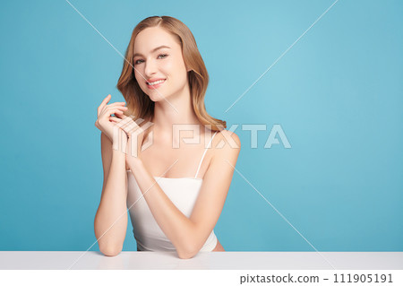 Beautiful young woman with clean fresh skin on blue background, Face care, Facial treatment, Cosmetology, beauty and spa, women portrait. Beautiful young woman with clean fresh skin on blue background, Face care, Facial treatment, Cosmetology, beauty and spa, women portrait. 111905191