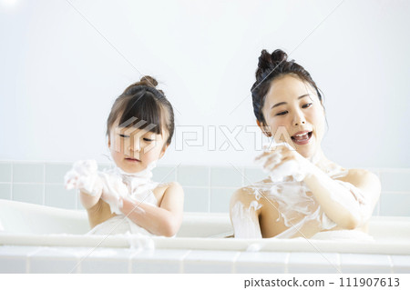 Parent and child entering the bath Parent and child entering the bath 111907613