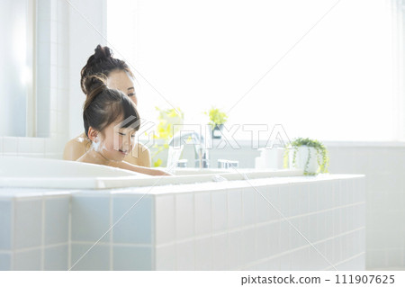 Parent and child entering the bath Parent and child entering the bath 111907625
